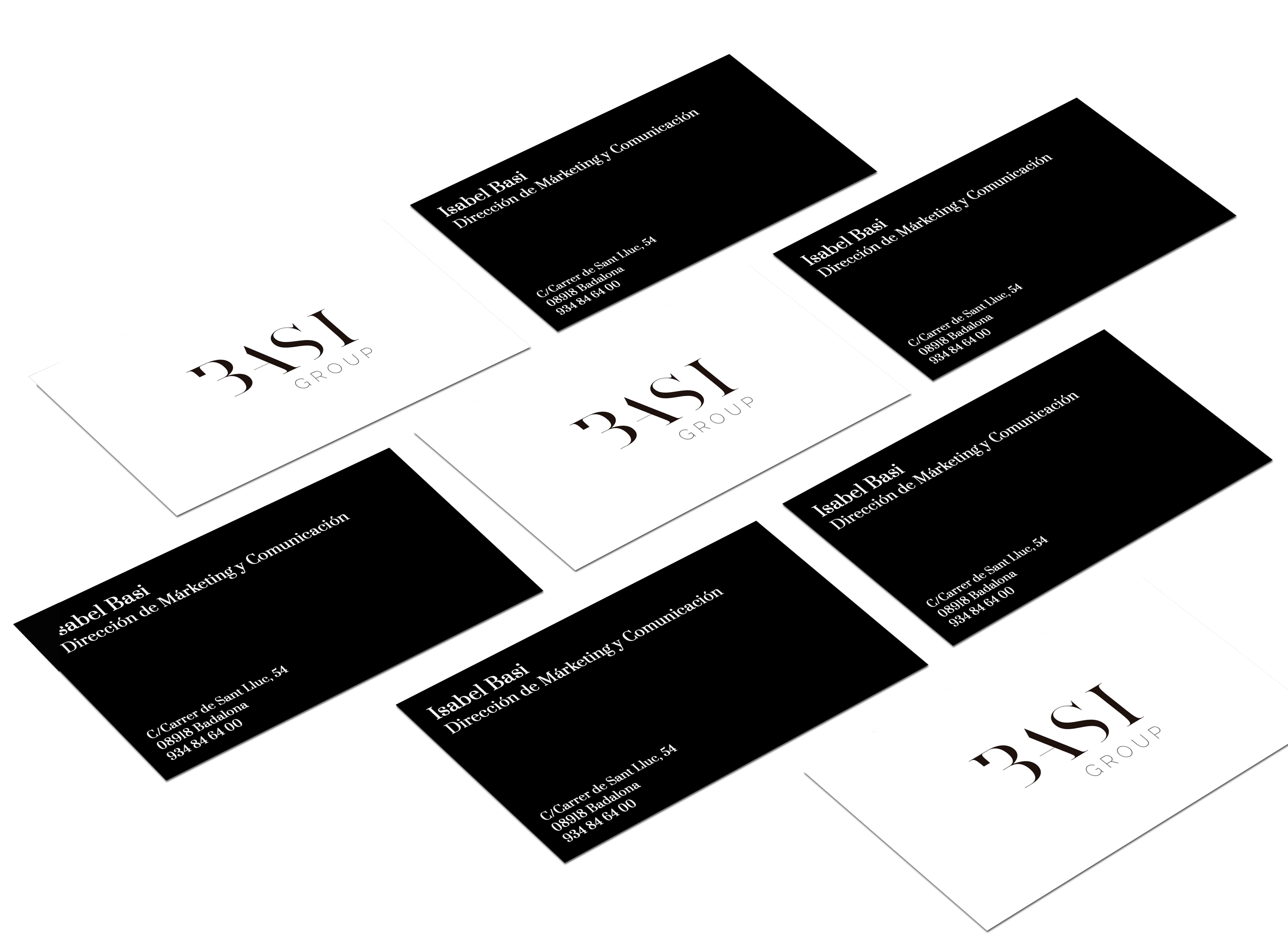 Stationery: Basi Group business cards in black and white, scattered across a white surface.